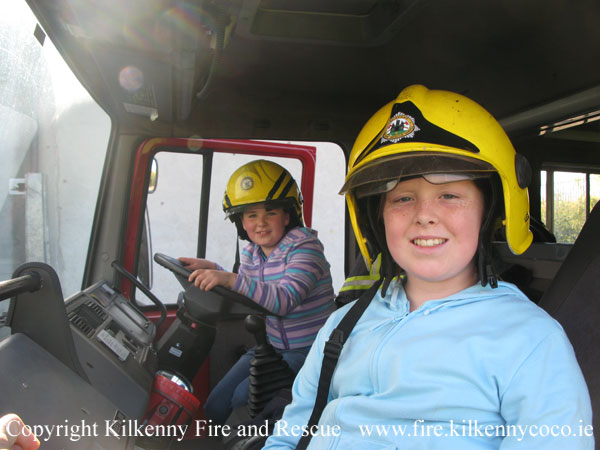 KCAN - Children try on the Firemans helmets