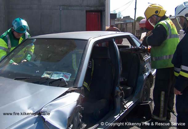 Firefighters making room in a vehicle at the scene of accident